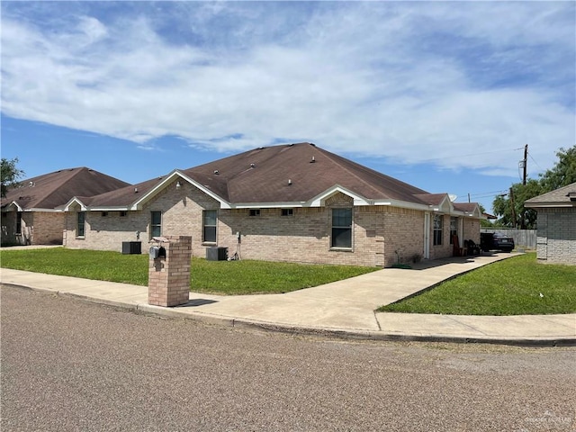 single story home featuring central air condition unit and a front lawn