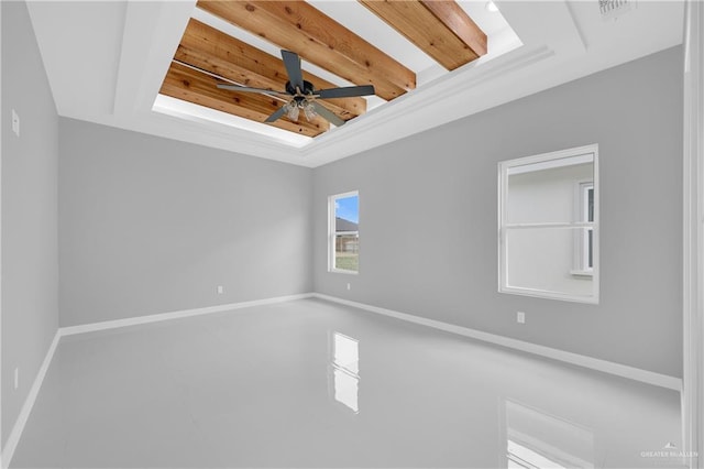 empty room featuring a raised ceiling, visible vents, ceiling fan, and baseboards