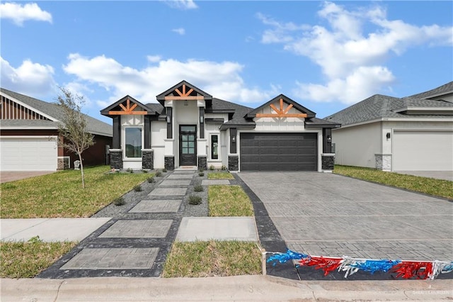 view of front of house featuring a front yard, decorative driveway, an attached garage, and stucco siding