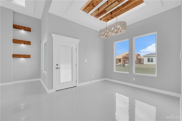 interior space featuring baseboards and an inviting chandelier