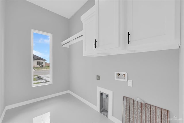 clothes washing area with baseboards, washer hookup, cabinet space, and hookup for an electric dryer