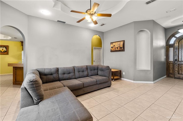 tiled living room with ceiling fan