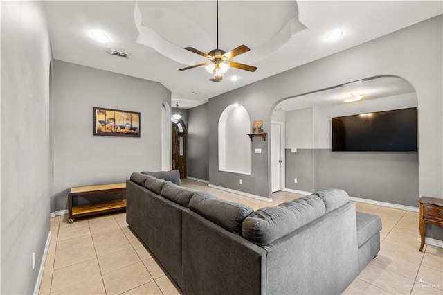 tiled living room with ceiling fan