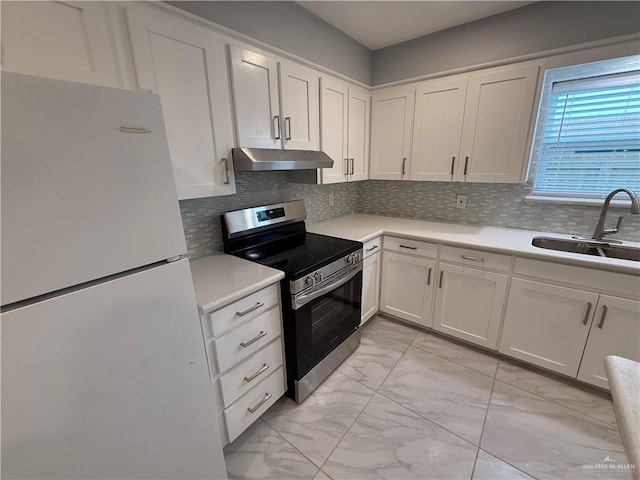 kitchen with electric stove, freestanding refrigerator, marble finish floor, under cabinet range hood, and a sink