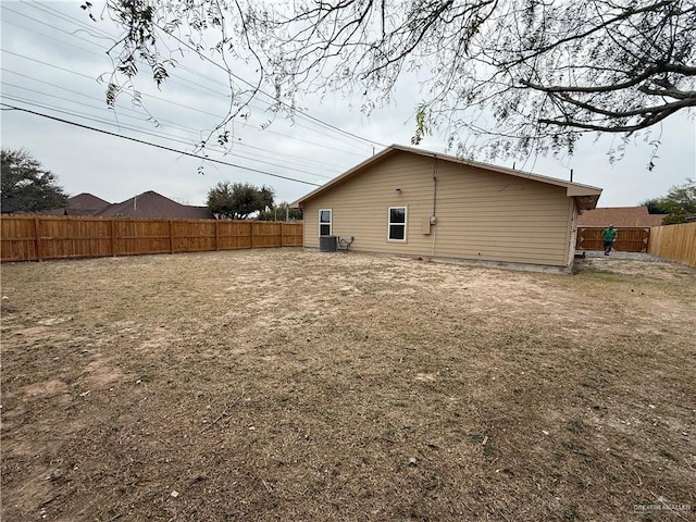 view of side of home featuring central air condition unit and a fenced backyard