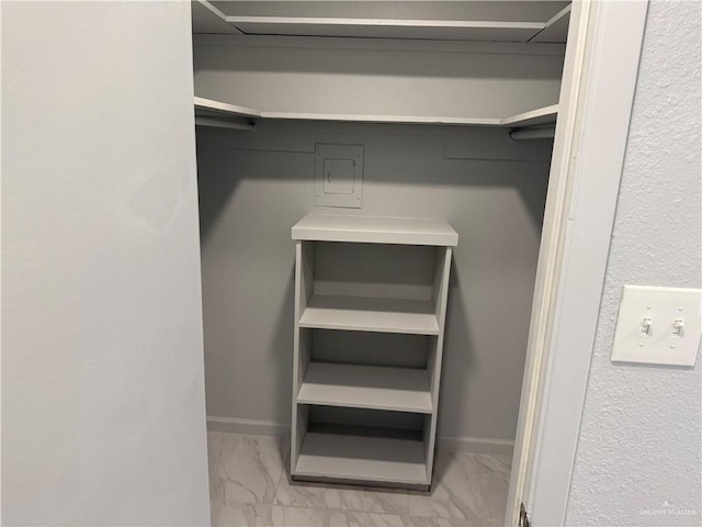 spacious closet with marble finish floor