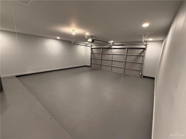 garage with baseboards and a garage door opener