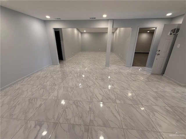 spare room featuring marble finish floor, recessed lighting, and baseboards