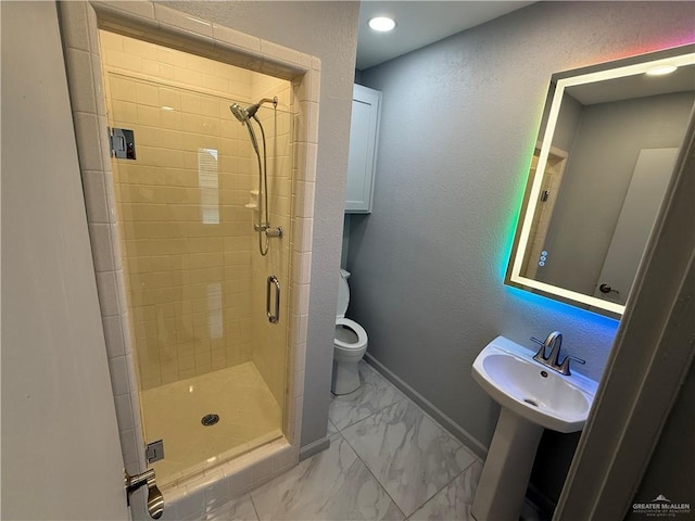 full bathroom with baseboards, a textured wall, toilet, marble finish floor, and a shower stall