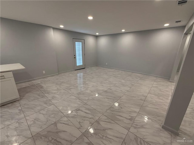 spare room featuring baseboards, marble finish floor, visible vents, and recessed lighting