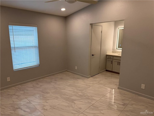 empty room featuring marble finish floor, recessed lighting, a ceiling fan, and baseboards