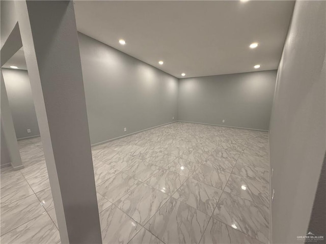 interior space featuring recessed lighting, marble finish floor, and baseboards