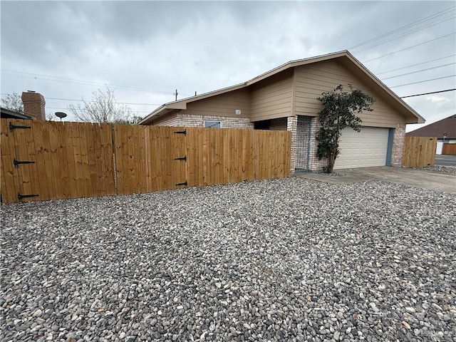 exterior space featuring brick siding and fence