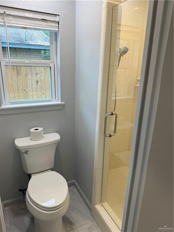 full bath featuring marble finish floor, a shower stall, toilet, and baseboards