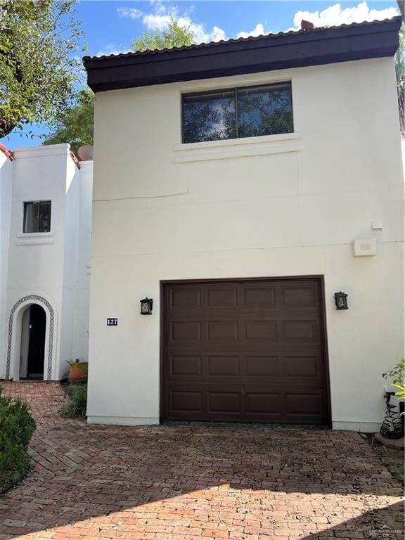 exterior space featuring decorative driveway