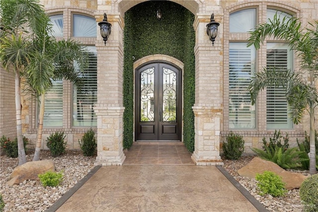 2502 Sandstone Dr, Mission, TX 78574 - view of exterior entry with french doors and stone siding