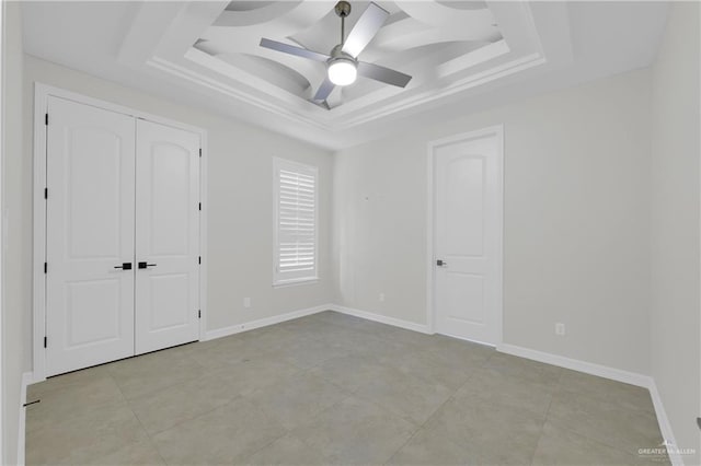 2502 Sandstone Dr, Mission, TX 78574 - unfurnished bedroom with a tray ceiling, a ceiling fan, baseboards, and a closet