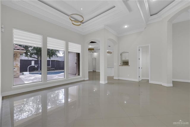 2502 Sandstone Dr, Mission, TX 78574 - tiled spare room with crown molding, plenty of natural light, arched walkways, baseboards, and a towering ceiling