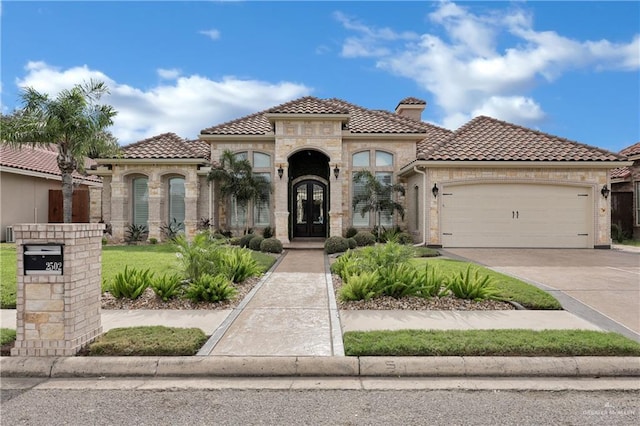 2502 Sandstone Dr, Mission, TX 78574 - mediterranean / spanish-style house featuring a tile roof, an attached garage, a chimney, and concrete driveway