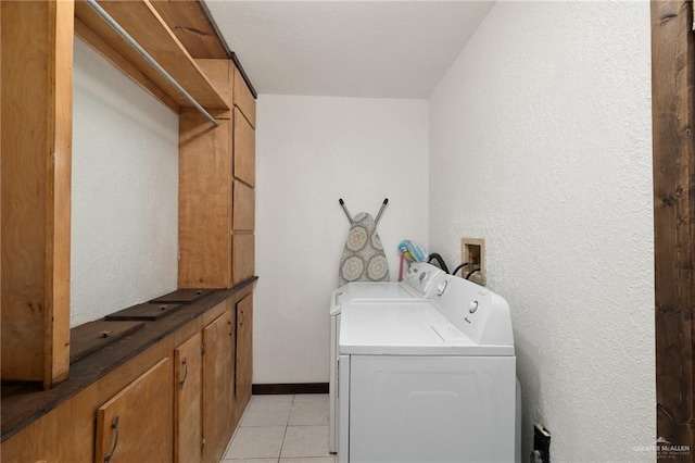2820 Joan Dr, Edinburg, TX 78541 - laundry area featuring washer and clothes dryer, light tile patterned floors, a textured wall, and baseboards