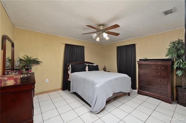 2820 Joan Dr, Edinburg, TX 78541 - bedroom featuring a textured ceiling, light tile patterned floors, ceiling fan, and baseboards