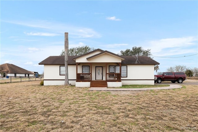 view of front of house with a porch and a front yard