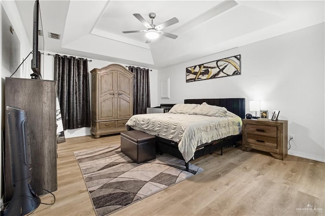 132 E Ciro Dr, San Juan, TX 78589 - bedroom featuring a tray ceiling, light wood-style floors, and a ceiling fan