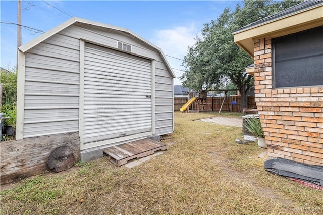 view of outbuilding with a playground and a lawn