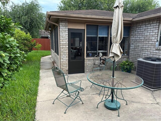 42 E Cherokee Dr, Harlingen, TX 78550 - view of patio / terrace with cooling unit and outdoor dining area