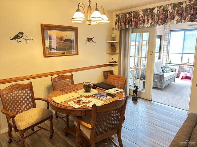 42 E Cherokee Dr, Harlingen, TX 78550 - dining room featuring a chandelier and wood finished floors