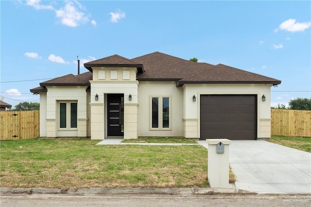 prairie-style house featuring a front yard and a garage