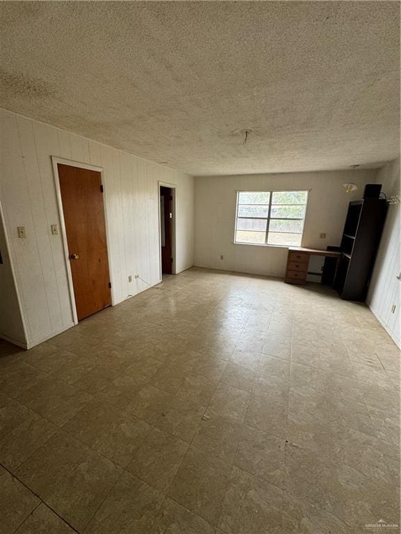 unfurnished room with a textured ceiling