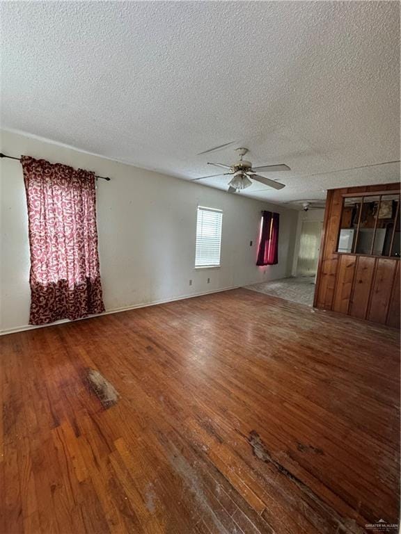 unfurnished room with a textured ceiling, hardwood / wood-style flooring, and ceiling fan