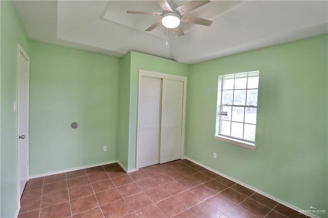 113 W Garfield Ave, San Juan, TX 78589 - unfurnished bedroom featuring a closet, dark tile patterned flooring, and a ceiling fan