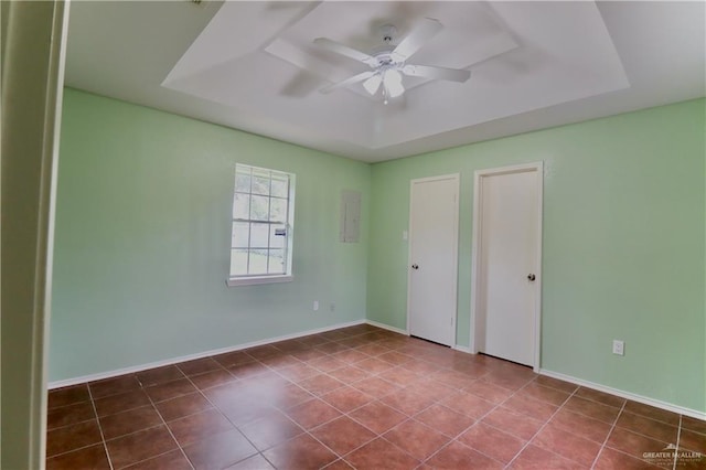 113 W Garfield Ave, San Juan, TX 78589 - unfurnished bedroom with a tray ceiling, a ceiling fan, and tile patterned flooring