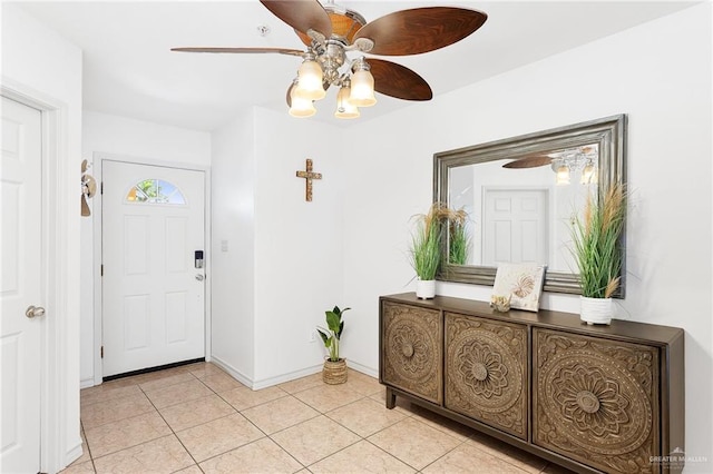 entrance foyer with ceiling fan and light tile patterned flooring