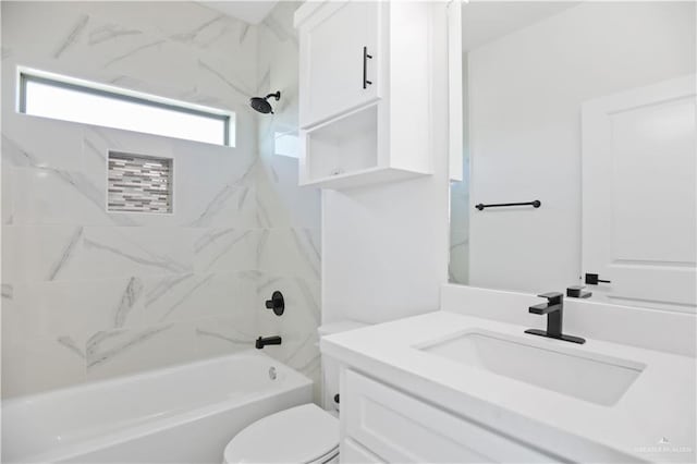 bathroom featuring vanity, shower / tub combination, and toilet