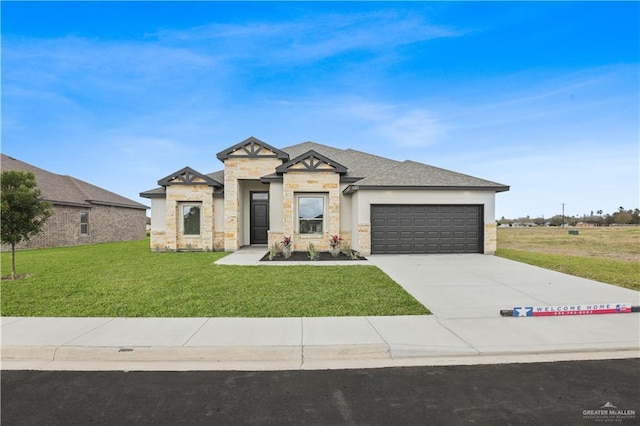 view of front of house with driveway, stone siding, an attached garage, and a front yard