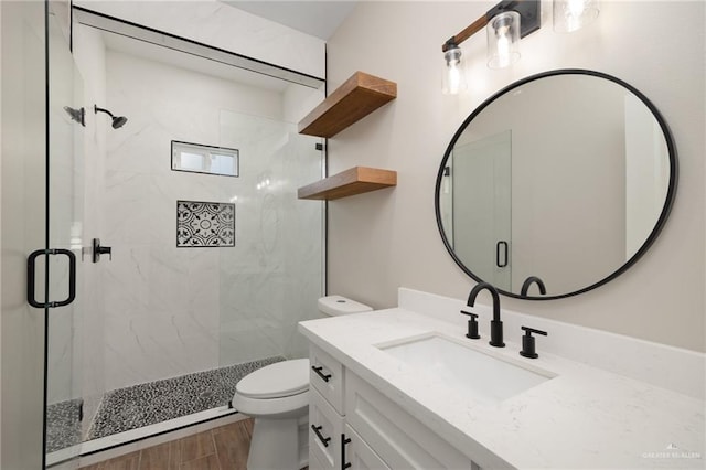 bathroom featuring hardwood / wood-style floors, vanity, an enclosed shower, and toilet