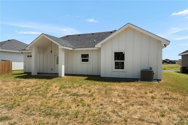 rear view of house featuring a yard and central AC