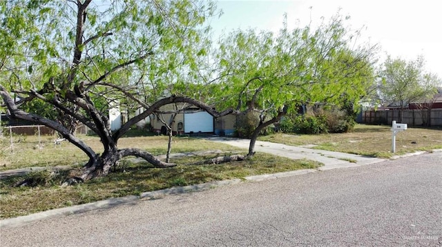 view of front of house featuring driveway and fence