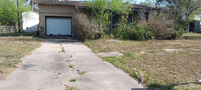 view of front facade with a garage, concrete driveway, and brick siding