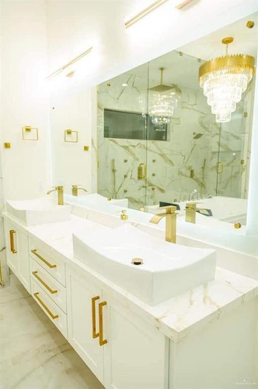 bathroom with vanity, an enclosed shower, and a chandelier