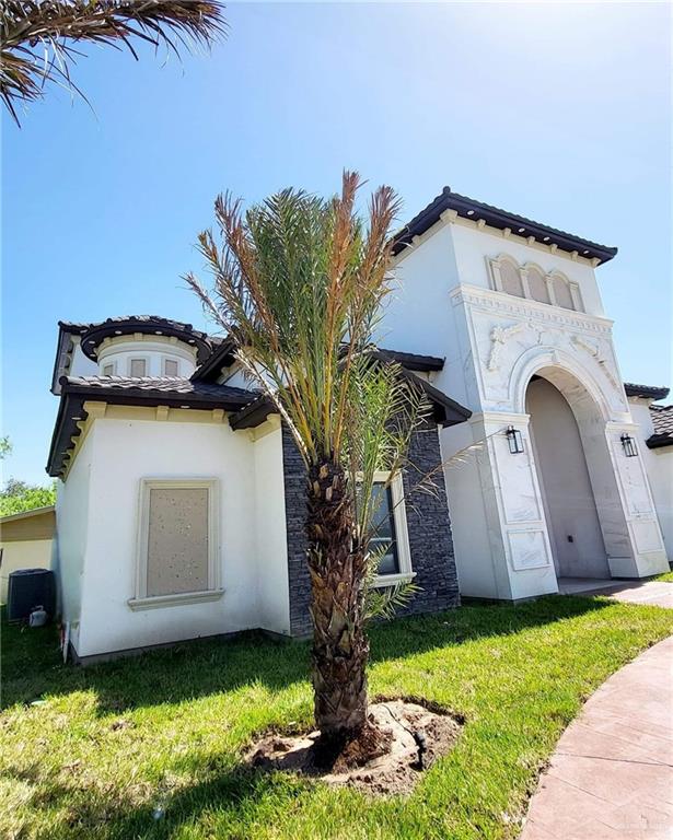 mediterranean / spanish-style house with a front yard