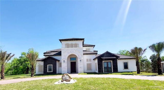 mediterranean / spanish-style house with a front lawn