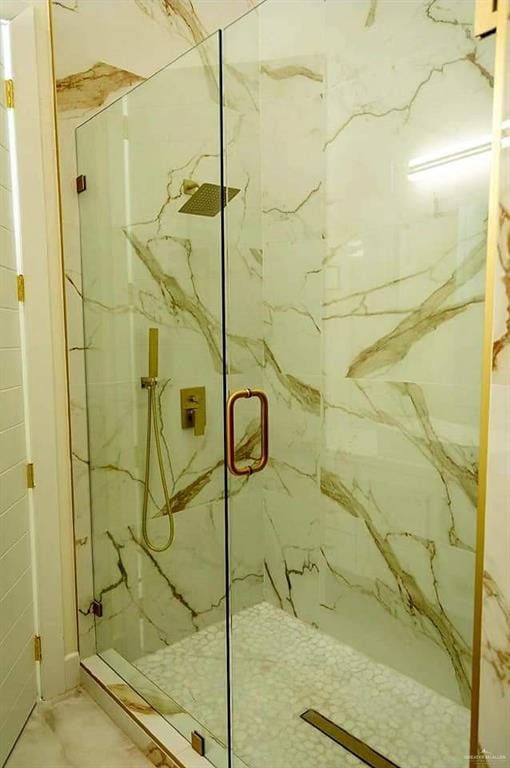 bathroom featuring a shower with shower door