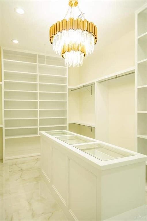 spacious closet with a notable chandelier