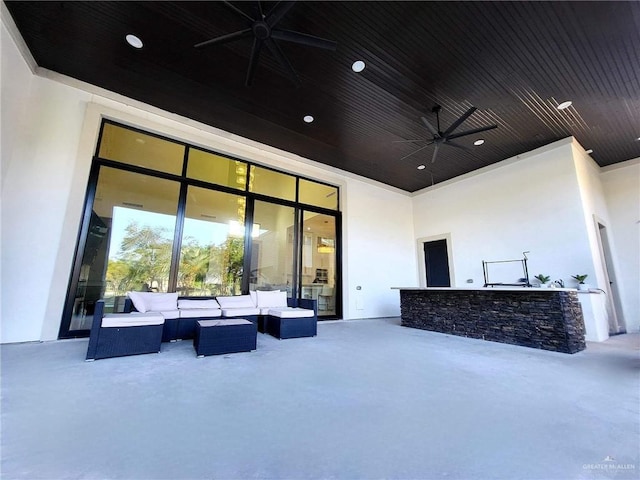 view of patio / terrace featuring outdoor lounge area, ceiling fan, and a bar