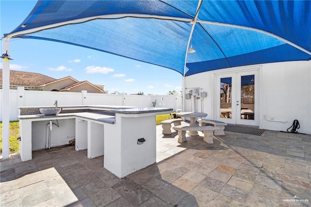 4004 Persimmon Dr, Palmhurst, TX 78573 - fenced backyard featuring french doors and a patio area