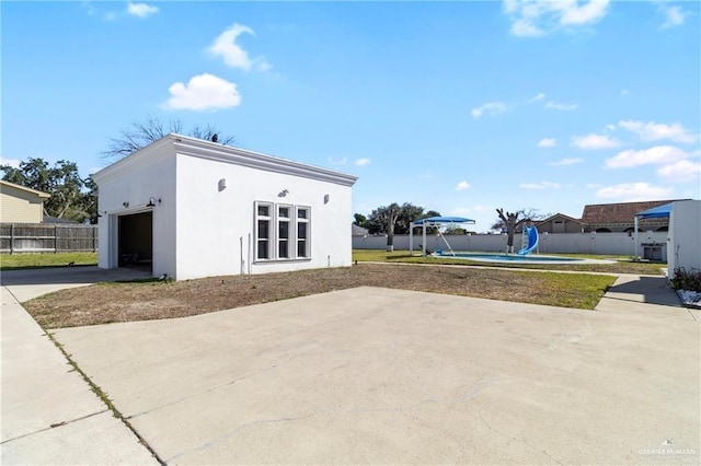 4004 Persimmon Dr, Palmhurst, TX 78573 - view of outdoor structure featuring concrete driveway and an attached garage